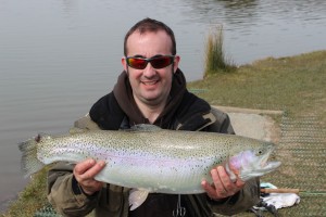 Lee Swords witha Roxhole rainbow trout of 12lb 9oz